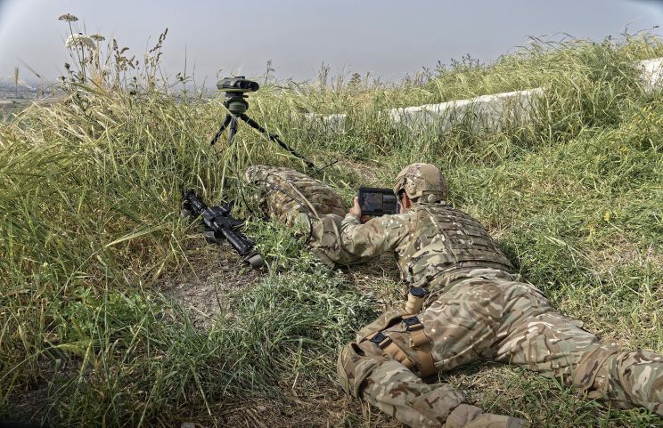The UK MoD has awarded ESUK a contract for D-JFI for the British armed forces. The photo shows a forward observer using a handheld display to examine the footage relayed by the optical system.  (Elbit)