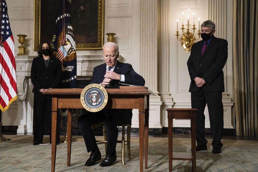 US President Joe Biden signs executive orders at the White House in Washington, DC, on 27 January 2021. The orders included tasks for national security teams to prioritise climate change.  (Anna Moneymaker-Pool/Getty Images)