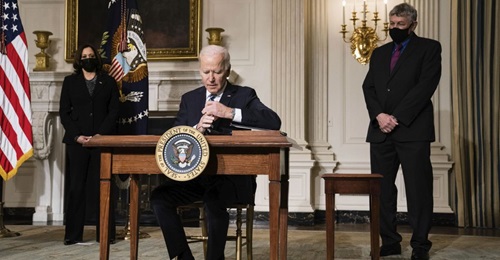 US President Joe Biden signs executive orders at the White House in Washington, DC, on 27 January 2021. The orders included tasks for national security teams to prioritise climate change.