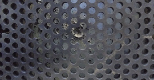 This image shows the TESA armour array, the fractured elements of a projectile have been caught by the armour plate to the rear.
