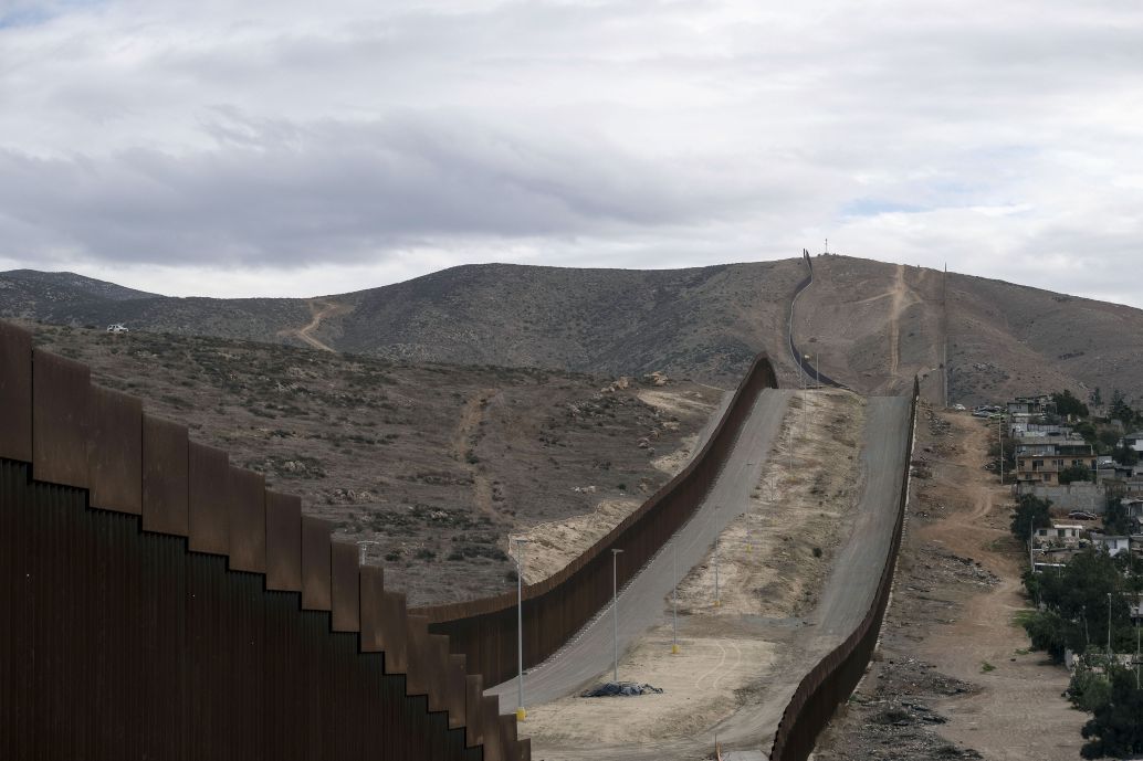 A section of the US-Mexico border wall runs alongside Tijuana, Baja California state, Mexico, on 20 January 2021. Under President Joe Biden, US border security policies are likely to become less militarised and more nuanced. (Guillermo Arias/AFP via Getty Images)