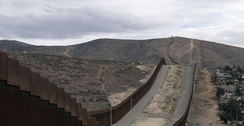 A section of the US-Mexico border wall runs alongside Tijuana, Baja California state, Mexico, on 20 January 2021. Under President Joe Biden, US border security policies are likely to become less militarised and more nuanced.