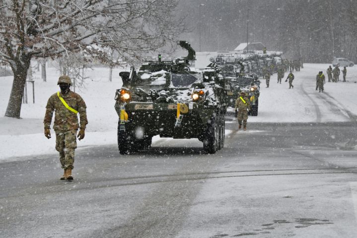 US soldiers assigned to 1st Squadron, 2nd Cavalry Regiment guide Stryker vehicles during railhead operations at Rose Barracks, Vilseck, Germany, in January. The army is working with Lockheed Martin on a MAPS base kit for multiple vehicle fleets. (US Army )