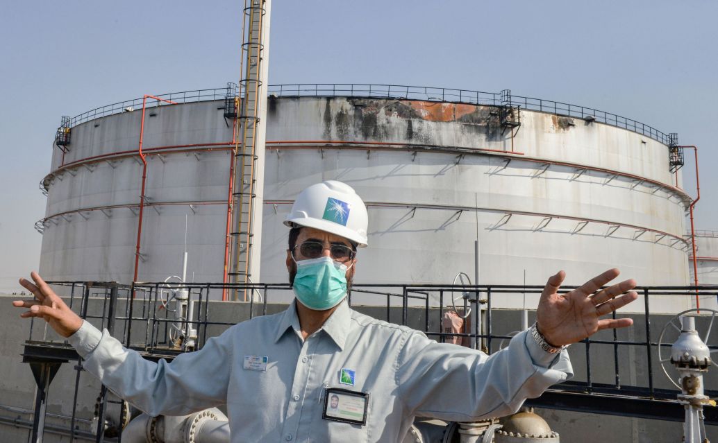 An employee at the Saudi Aramco oil facility stands near a silo at a plant in Saudi Arabia's Red Sea city of Jeddah on 24 November 2020. The facility was damaged during an attack the previous day by Yemen-based Houthi militants.  (Fayez Nureldine/AFP via Getty Images)