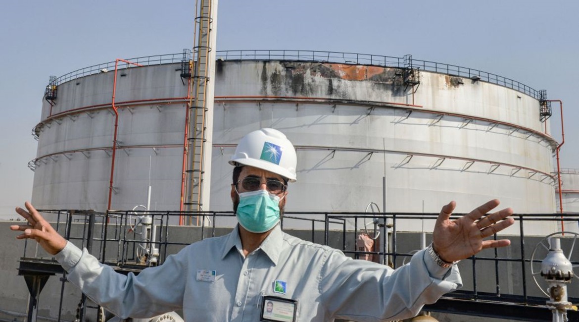 An employee at the Saudi Aramco oil facility stands near a silo at a plant in Saudi Arabia's Red Sea city of Jeddah on 24 November 2020. The facility was damaged during an attack the previous day by Yemen-based Houthi militants.