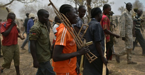 Trainee soldiers for a new unified army carry wooden rifles while attending a reconciliation programme run by the UN Mission in South Sudan (UNMISS) at a makeshift barracks in Mapel in January 2020. The South Sudanese armed forces are being plagued by ...