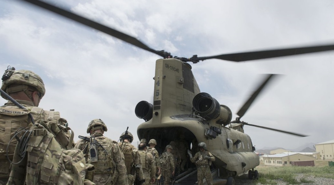 US soldiers enter a CH-47 Chinook helicopter at an Afghan National Army combat outpost in Afghanistan on 23 June 2015. Biden announced on 14 April that the remaining 2,500 US troops in Afghanistan are set to leave the Central Asian country before 11 Se...