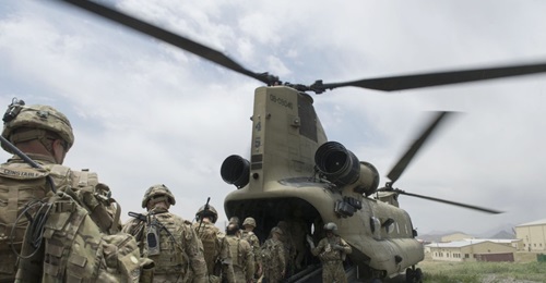 US soldiers enter a CH-47 Chinook helicopter at an Afghan National Army combat outpost in Afghanistan on 23 June 2015. Biden announced on 14 April that the remaining 2,500 US troops in Afghanistan are set to leave the Central Asian country before 11 Se...