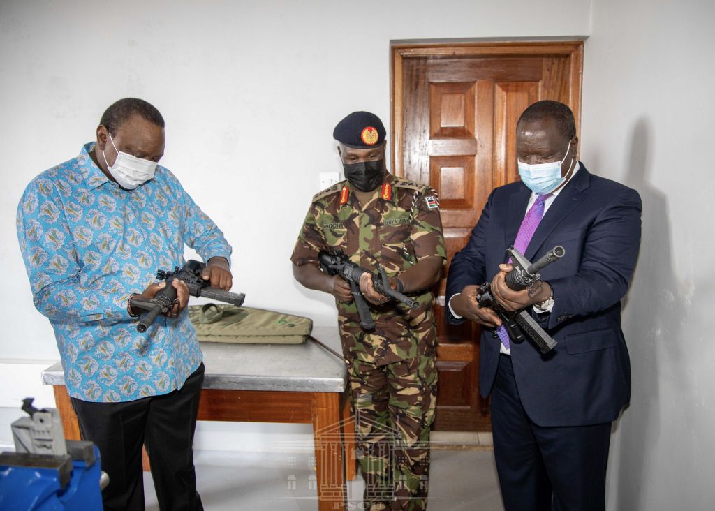 President Kenyatta (left) inspects one of the rifles produced by the new Small Arms Factory. (State House Kenya)
