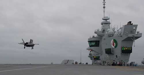 An F-35B prepares to land aboard the RN carrier HMS 
        
        . In March, the Naval Air Traffic Management Systems Program Office completed a critical step in readying the ship for its first operational deployment with PALS certificati...