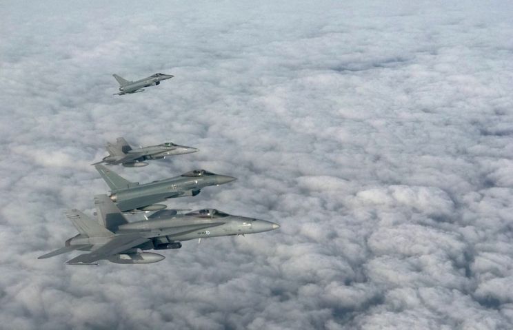 An archive image showing BAP Eurofighters conducting joint training drills with NATO partner Finland’s F/A-18s. (NATO)