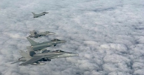 An archive image showing BAP Eurofighters conducting joint training drills with NATO partner Finland's F/A-18s.