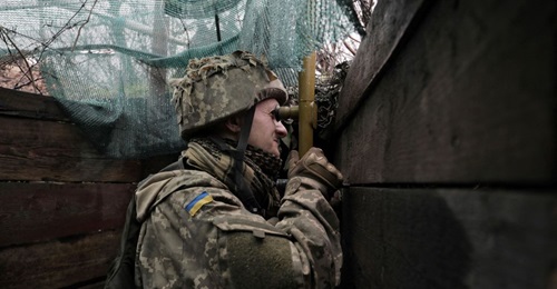 A Ukrainian soldier uses a periscope on the front line with Russian-backed separatists near Marinka, Donetsk, on 20 April.