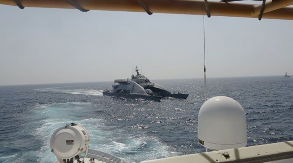 The IRGCN's fast transport ship 
        
         cuts across the bow of a US Coast Guard Cutter 
        
         on 2 April.