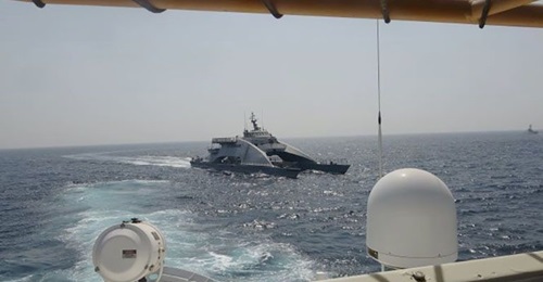 The IRGCN's fast transport ship 
        
         cuts across the bow of a US Coast Guard Cutter 
        
         on 2 April.