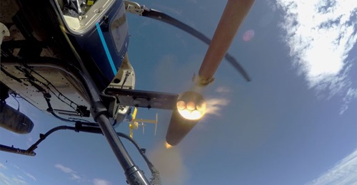 A Thales FZ90 70 mm/2.75” rocket motor body is fired from an Arnold Defense M260 air launcher mounted on a Bell 407 utility helicopter during qualification tests at Dillon Aero's test range near Maricopa, Arizona in January.