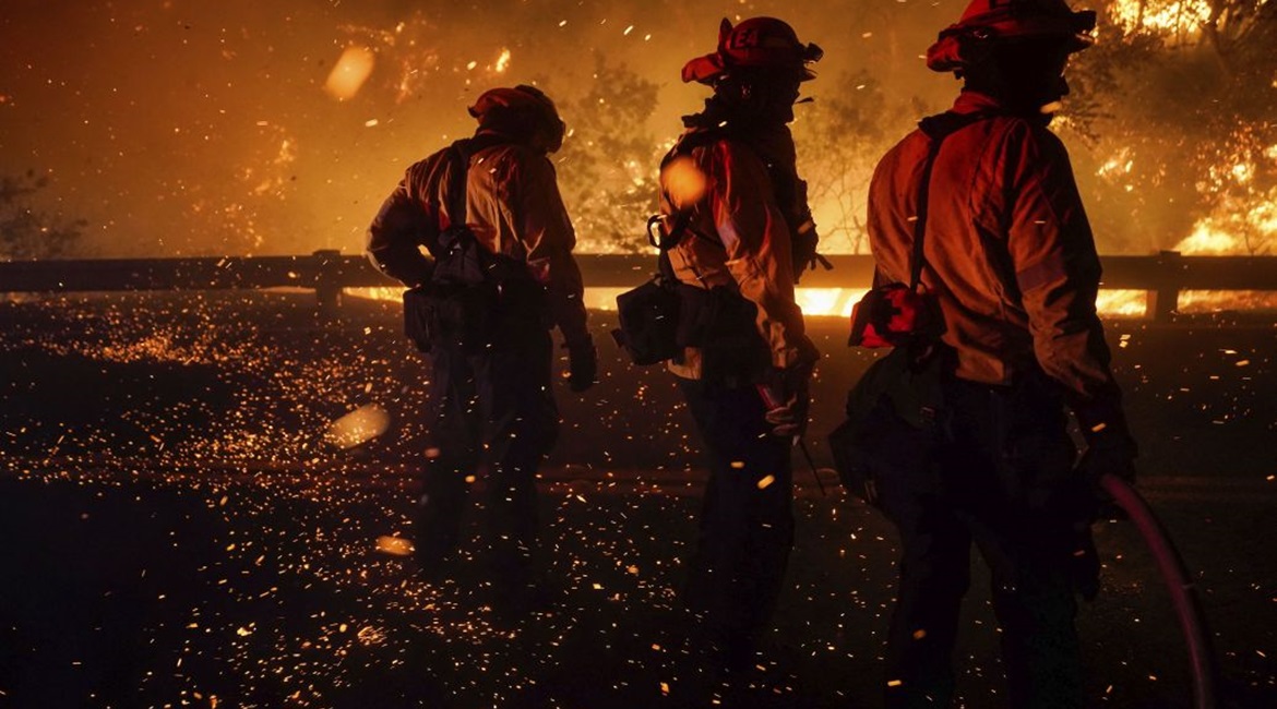 Firefighters tackle a fire in vegetation in Silverado, California, on 3 December 2020. Climate change is increasing in prevalence in national security and intelligence assessments.