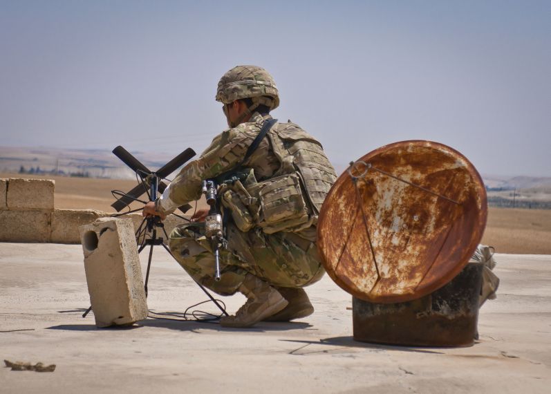 A US soldier sets up an antenna during a co-ordinated patrol with the Turkish military forces along the demarcation line outside Manbij, Syria. (US Army)