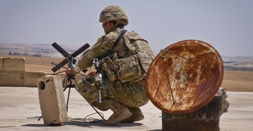 A US soldier sets up an antenna during a co-ordinated patrol with the Turkish military forces along the demarcation line outside Manbij, Syria.