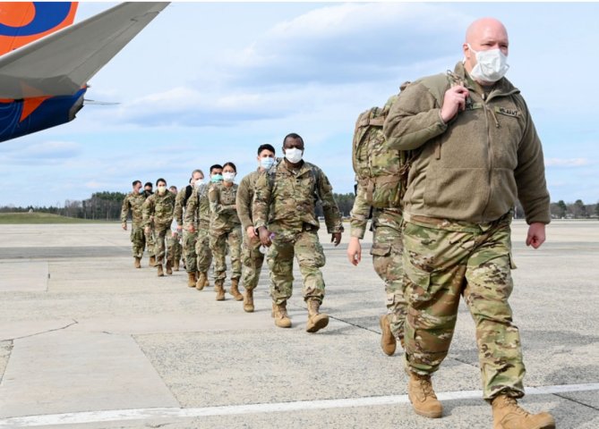US Army Reserve Soldiers assigned to Urban Augmentation Medical Task Forces arrive at Hanscom Air Force Base, Massachusetts on 17 April, 2020. Officials with the Pentagon’s National Geospatial Intelligence Agency are developing a predictive analysis programme to mitigate future Covid-19 outbreaks.  (Credit: US Department of Defense)